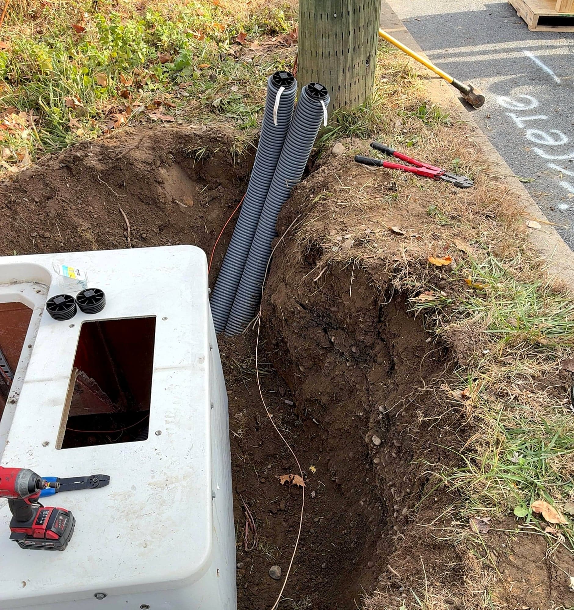 Open handhole with conduit ready for fiber