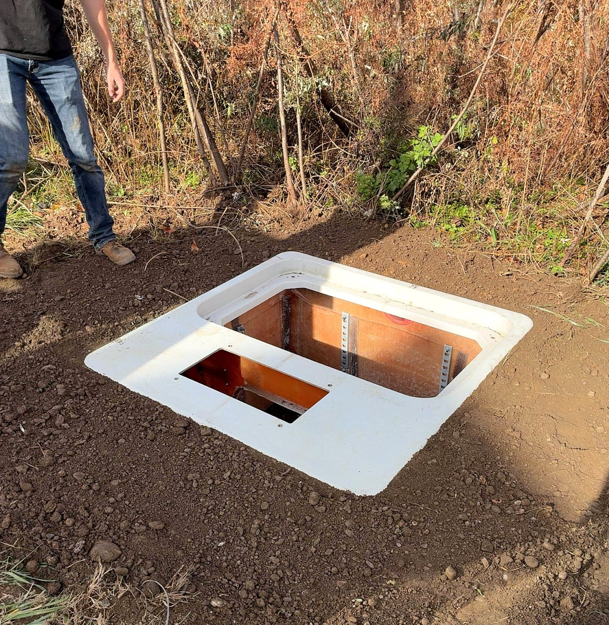 Precast utility vault being set in the ground